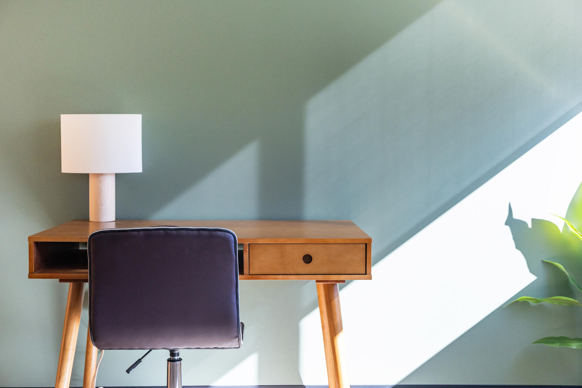 Therapy office workspace with a wooden desk and chair